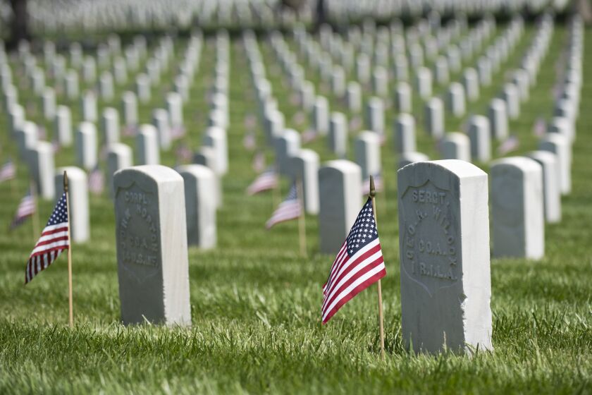 Flags adorn he headstones of veterans at the Los Angeles National Cemetery on Memorial Day, Monday, May 31, 2021. Nick Agro / For The Times )