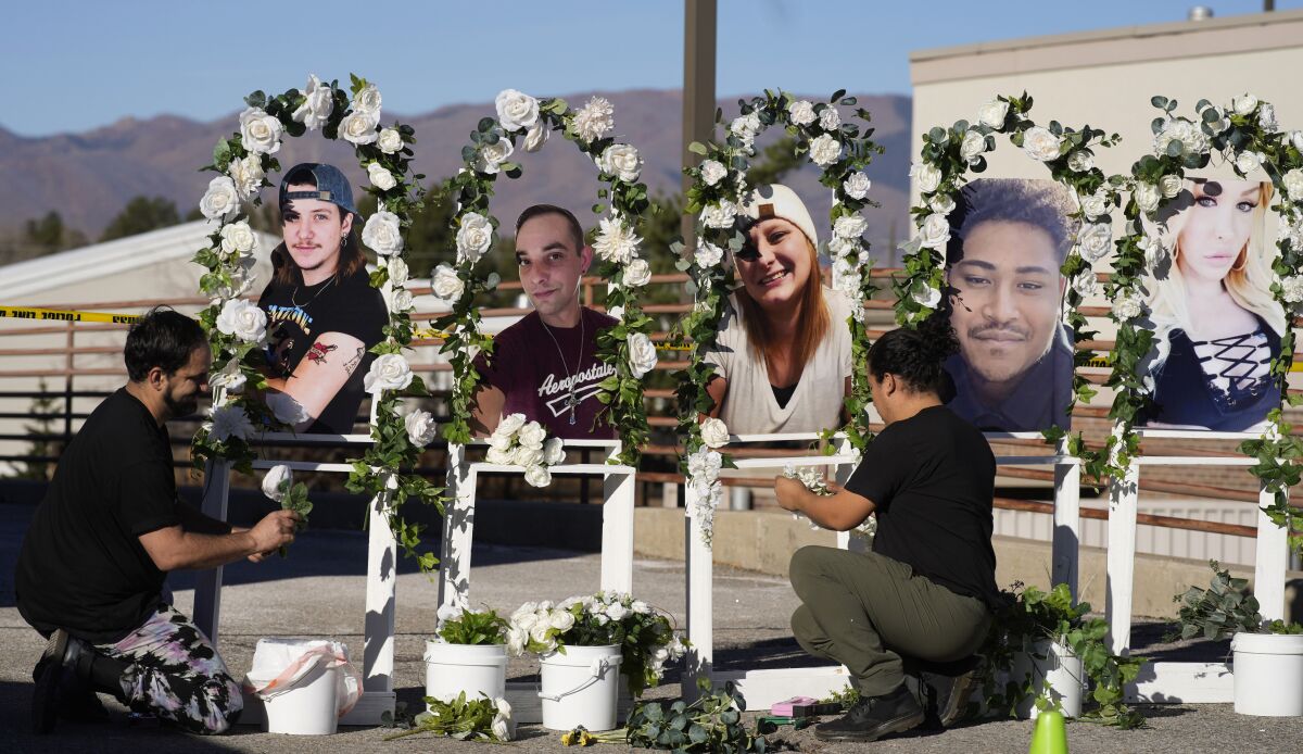 Two men erected a memorial with five photographs of the five victims of the Colorado Springs mass shooting.