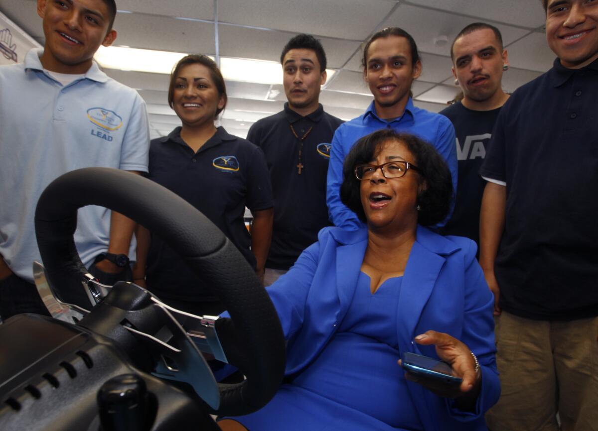 Jan Perry has been confirmed as head of the Economic and Workforce Development Department. Pictured in September, she laughs after she fails at driving and texting while at the wheel of a vehicle simulator at a driver education event in East Los Angeles.