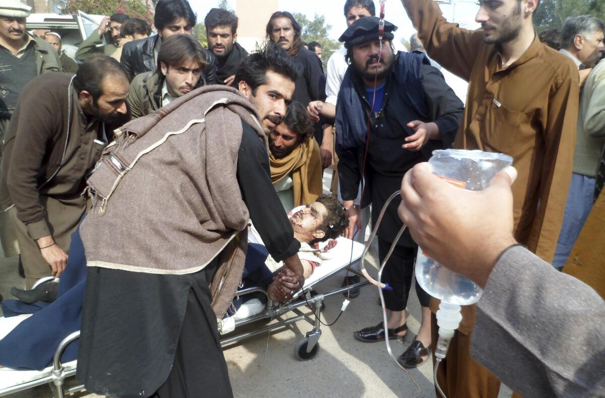 A Pakistani man who was injured in a bomb blast is rushed to a hospital Sunday in Kohat, Pakistan.