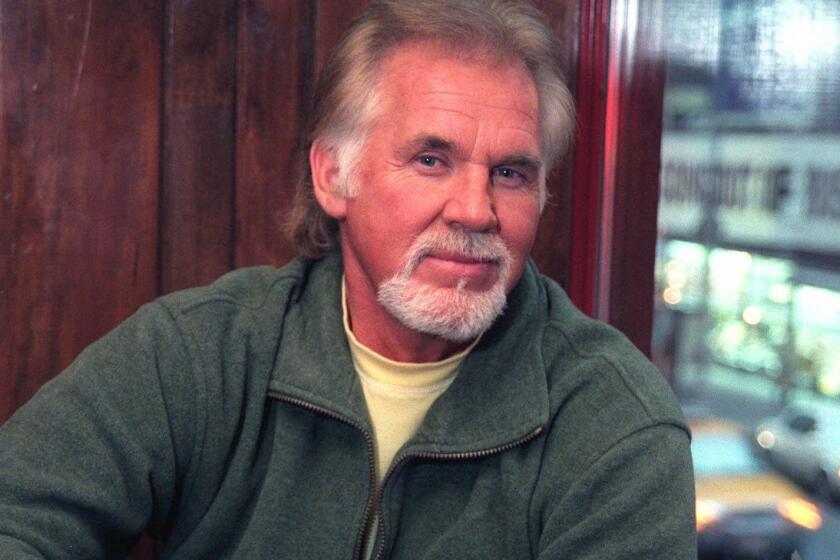 FILE--Singer Kenny Rogers poses following an interview in New York in this Nov. 10, 1998, file photo. Rogers has sued his manager of 33 years after firing him two months ago. Rogers last week filed a lawsuit in Davidson County Circuit Court against Ken Kragen, saying that he had been disloyal and lured away new teen trio 3 of Hearts from Rogers' Dreamcatcher Management Co. to Kragen's own management company. (AP Photo/Suzanne Mapes, File) ORG XMIT: NY107