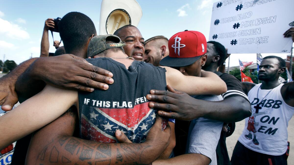 All Lives Matter protesters come together for a group hug with Black Lives Matter activists in Dallas on Sunday.