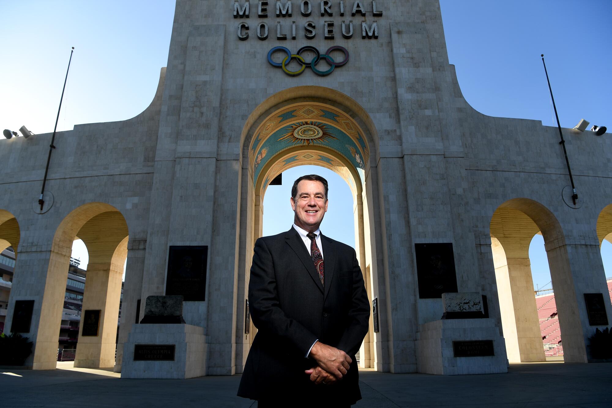 USC athletic director Mike Bohn stands inside the Coliseum.