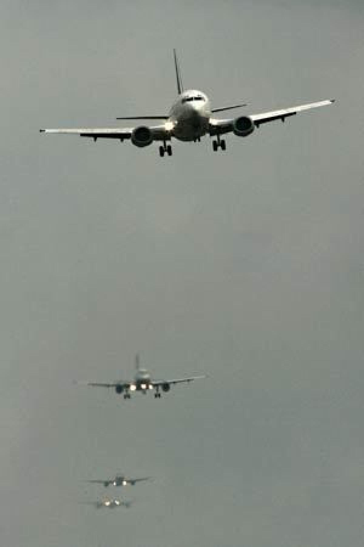 Airplanes line up to land at Heathrow airport.