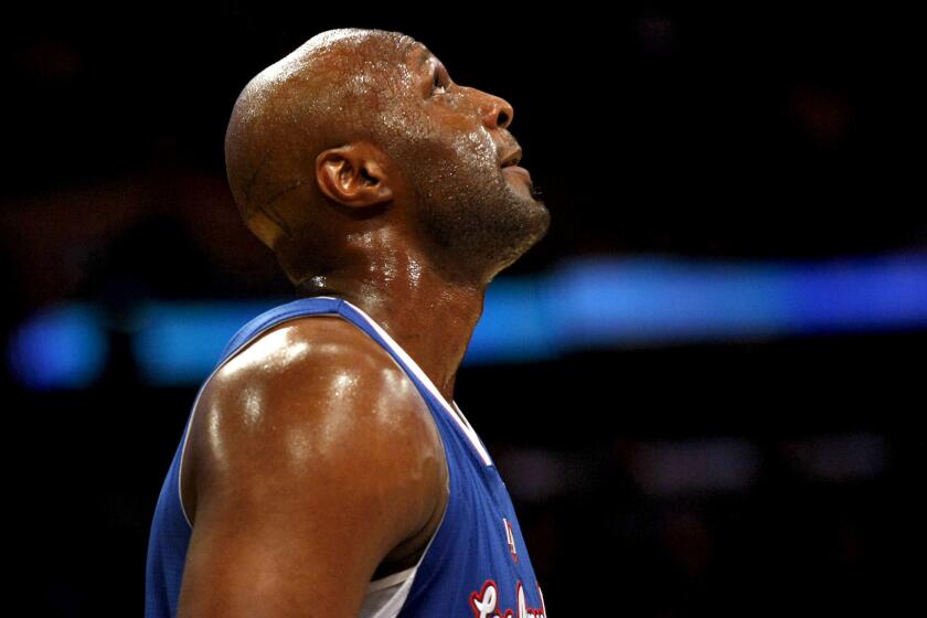 Lamar Odom checks the scoreboard during a game with the Clippers on Nov. 2, 2012.