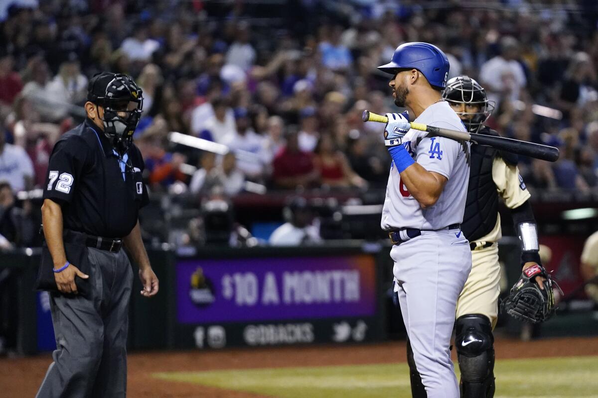 David Peralta, right, looks back at umpire Alfonso Marquez after being called out on strikes in the eighth inning.