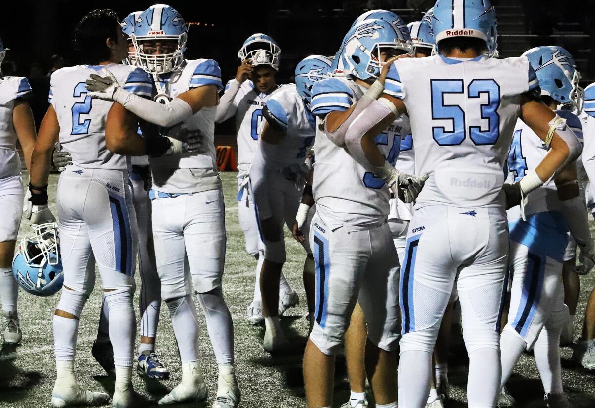 Corona del Mar's players console each other after losing to La Serna in the Division 4 title game on Friday night.