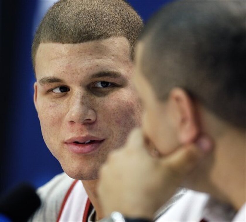 Oklahoma forward Blake Griffin, left, glances at head coach Jeff Capel during a news conference at the men's NCAA college basketball tournament in Memphis, Tenn., Saturday, March 28, 2009. Griffin's brother, Taylor, is at left. Oklahoma will play North Carolina in the regional championship game Sunday. (AP Photo/Jeff Roberson)