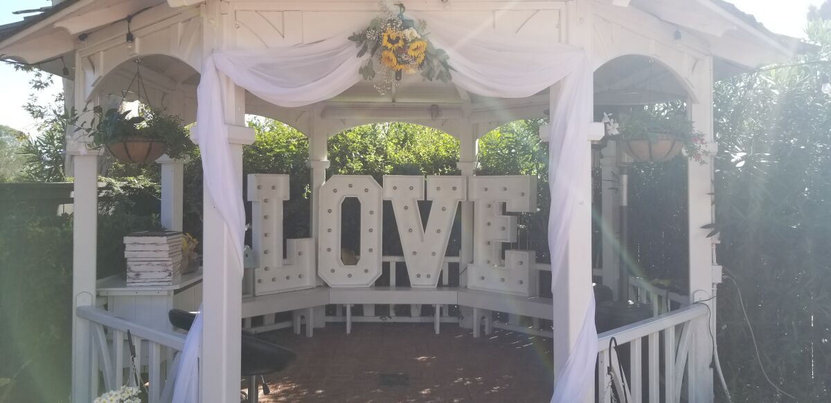 The gazebo is decked out with flowers and a large light-up ‘LOVE’ sign, hand-crafted by Frank and Letizia Gaxiola.