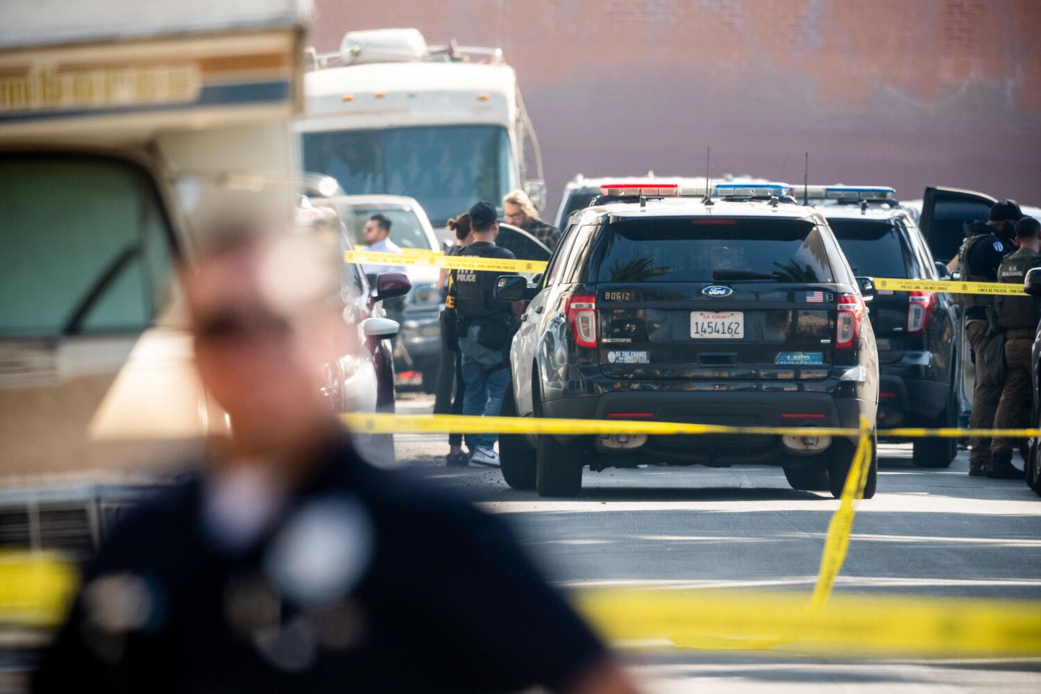 Los Angeles, CA, United States - October 21: Police gather at the scene of where a deputy U.S. marshal working on a federal immigration enforcement task force was wounded during an operation in South Los Angeles on Tuesday, Oct. 21, 2025 in Los Angeles, CA. (Ethan Swope/For The Times)