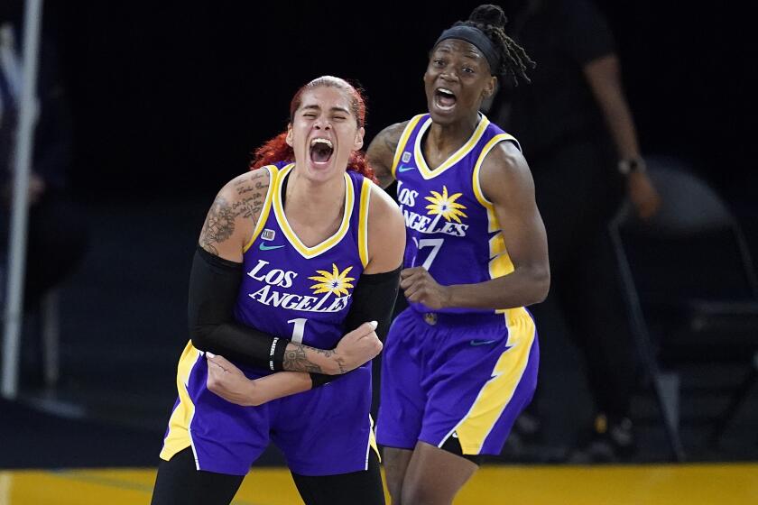 Los Angeles Sparks center Amanda Zahui B, left, and Erica Wheeler celebrate after a turnover by the Washington Mystics.