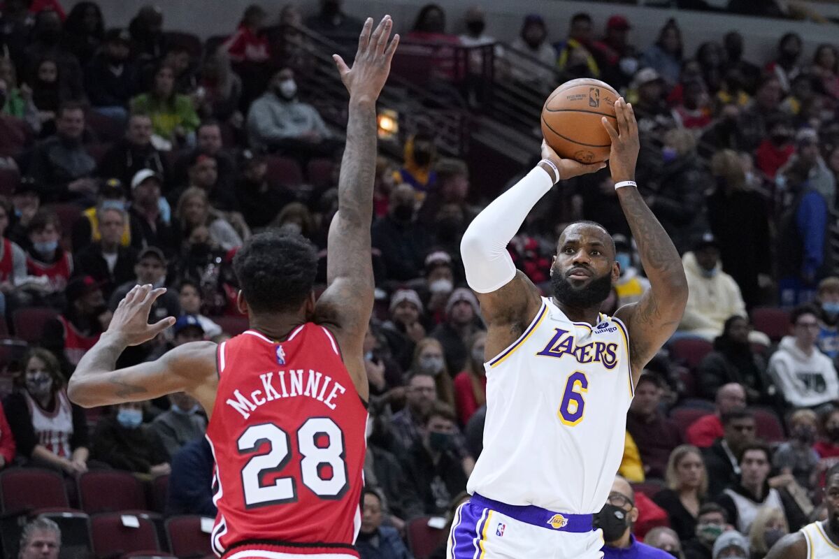 Lakers forward LeBron James shoots over Chicago Bulls forward Alfonzo McKinnie in the first half.