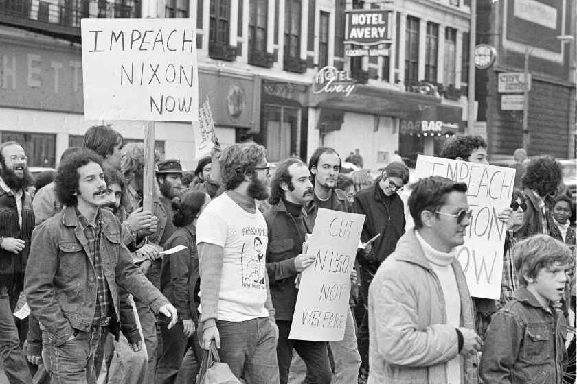 About 200 demonstrators paraded downtown Boston, Oct. 23, 1973 to urge the impeachment of President Nixon. The marchers said they were a coalition of groups who have banded together to for the Committee to Remove Our President. (AP Photo/J. Walter Green)