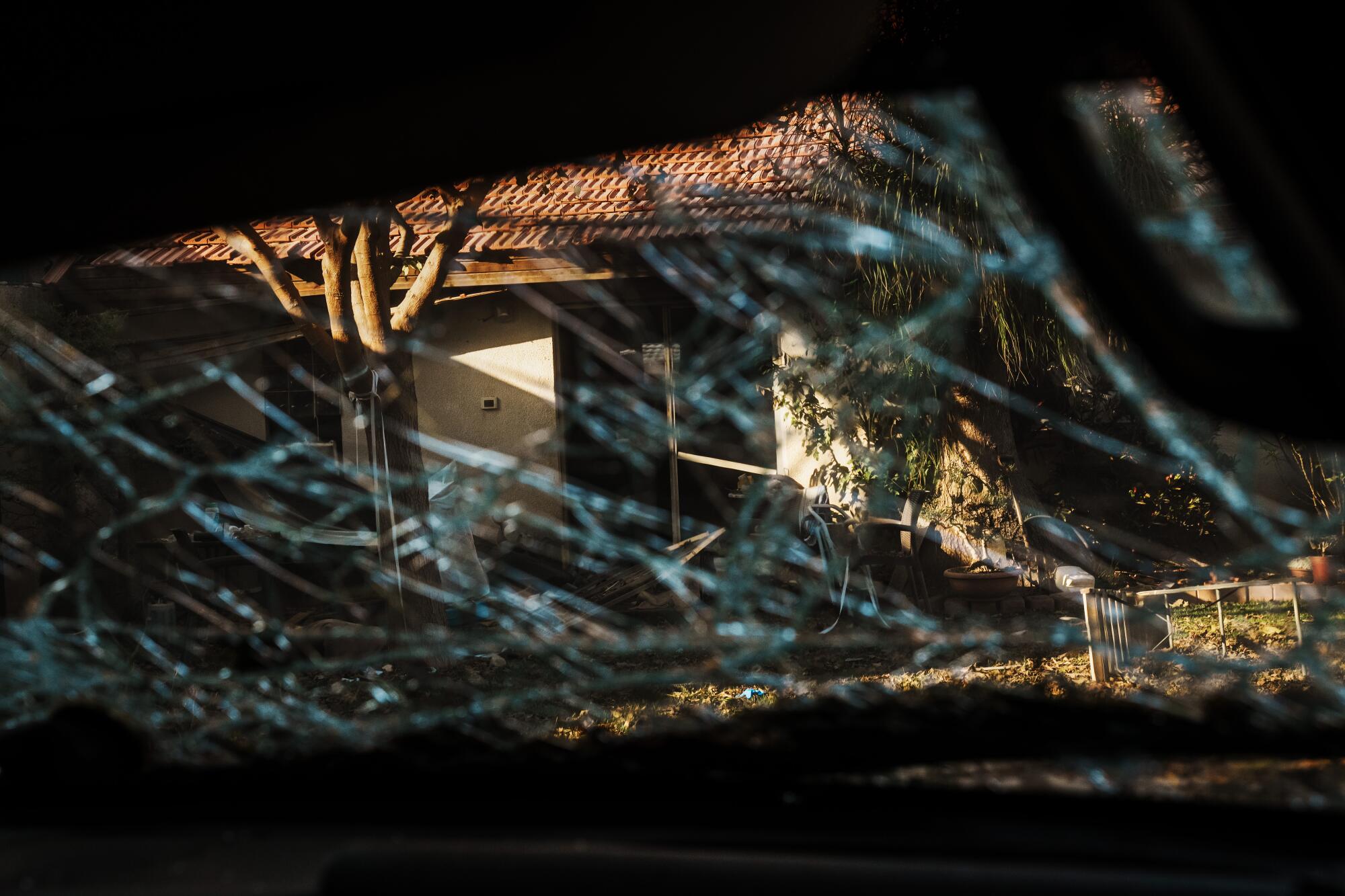 A view of a building seen through shattered glass