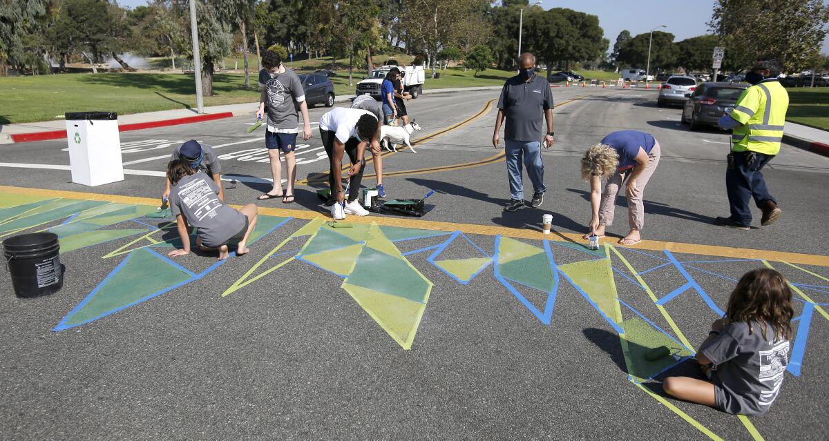 Volunteers helped paint the crosswalk at Junipero and Arlington drives in Costa Mesa on Oct. 3, 2020.