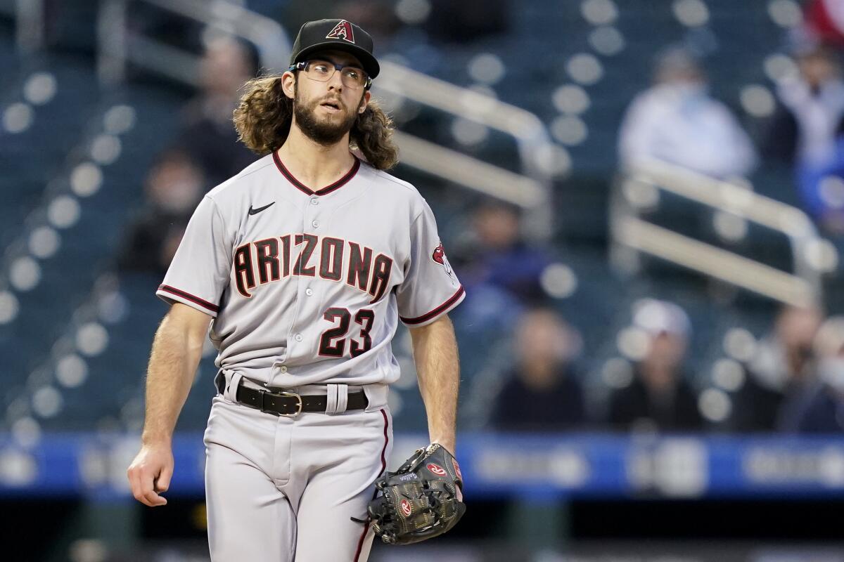 Arizona Diamondbacks starting pitcher Zac Gallen reacts after throwing in the first inning of a baseball game against the New York Mets, Friday, May 7, 2021, in New York. (AP Photo/John Minchillo)