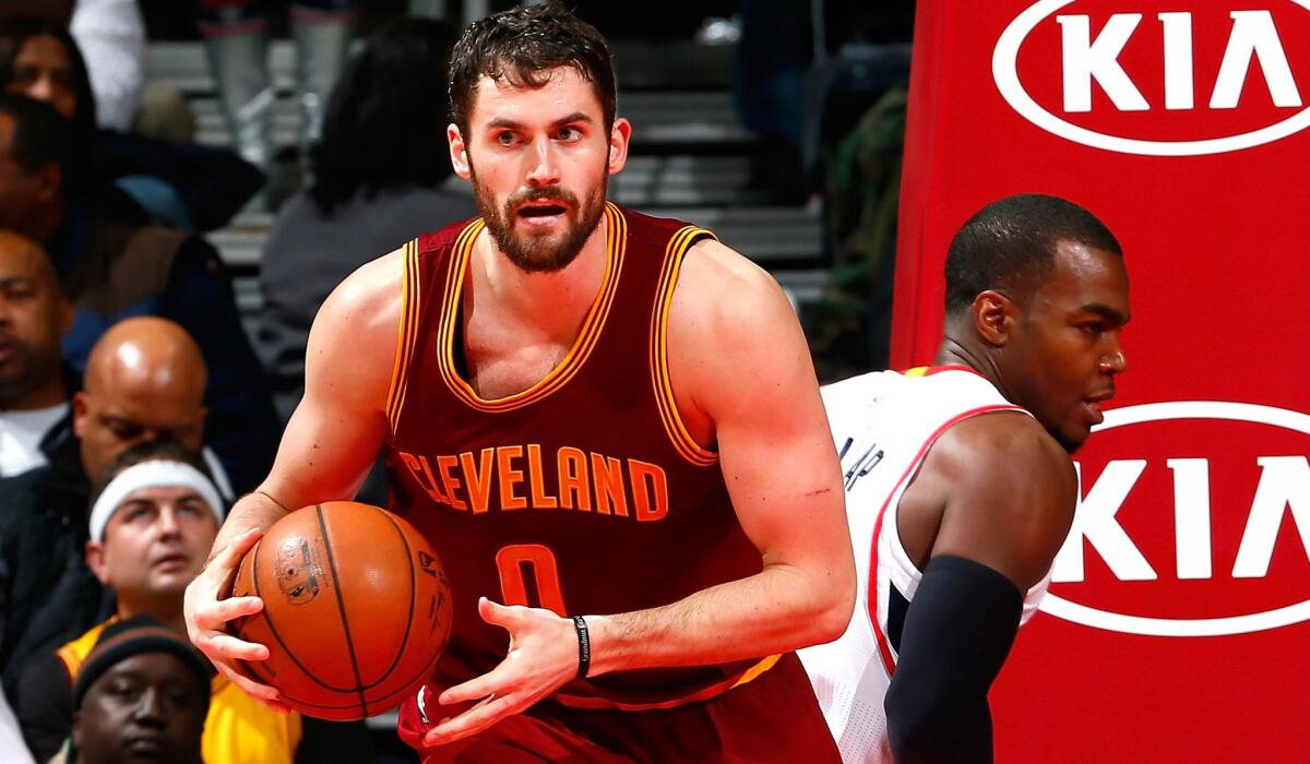 Cavaliers forward Kevin Love, looks to outlet after beating Hawks forward Paul Millsap to a rebound, can opt out of his contract with Cleveland this summer.