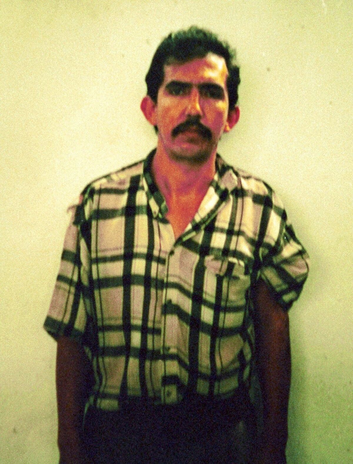 FILE - In this photo released by Colombian police, Luis Alfredo Garavito is seen in this undated police mug shot in Bogota, Colombia. A proposal to grant early release from prison to Garavito, one of the world's most prolific serial killers who confessed to killing about 190 children, has raised outrage in Colombia and a denunciation on Monday, Nov. 1, 2021 from President Iván Duque. (Colombia Police via AP, File)