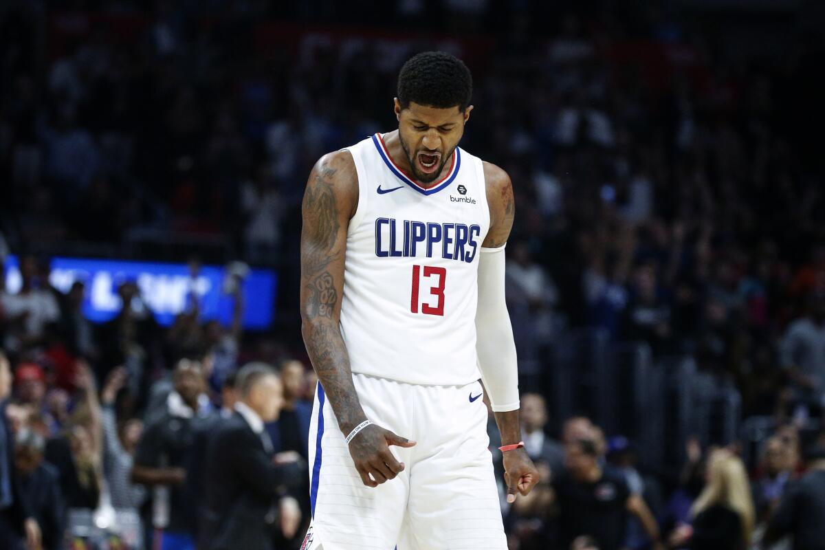 Clippers forward Paul George (13) reacts after hitting a 3-pointer against the Thunder during a game Nov. 18 at Staples Center.