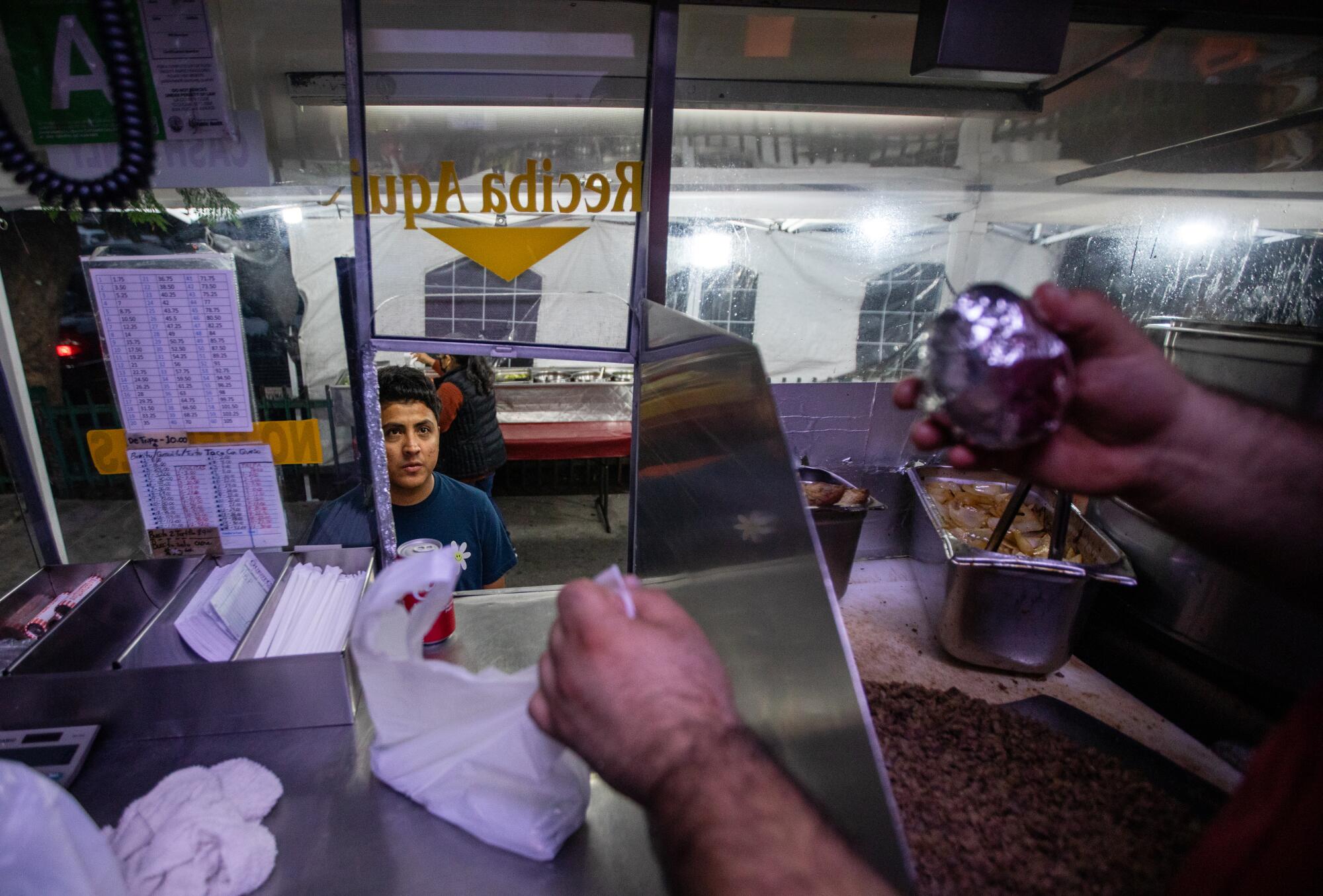 A view of a customer from inside a food truck