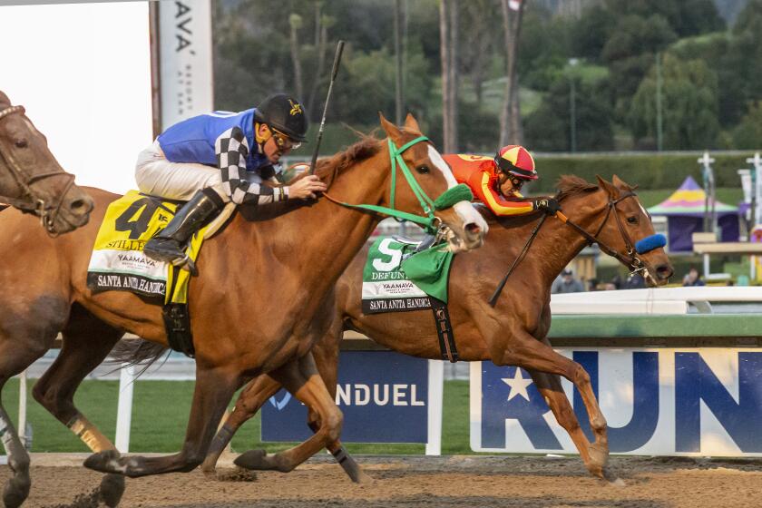 In a photo provided by Benoit Photo, Stilleto Boy and jockey Kent Desormeaux, left, overpower Defunded.