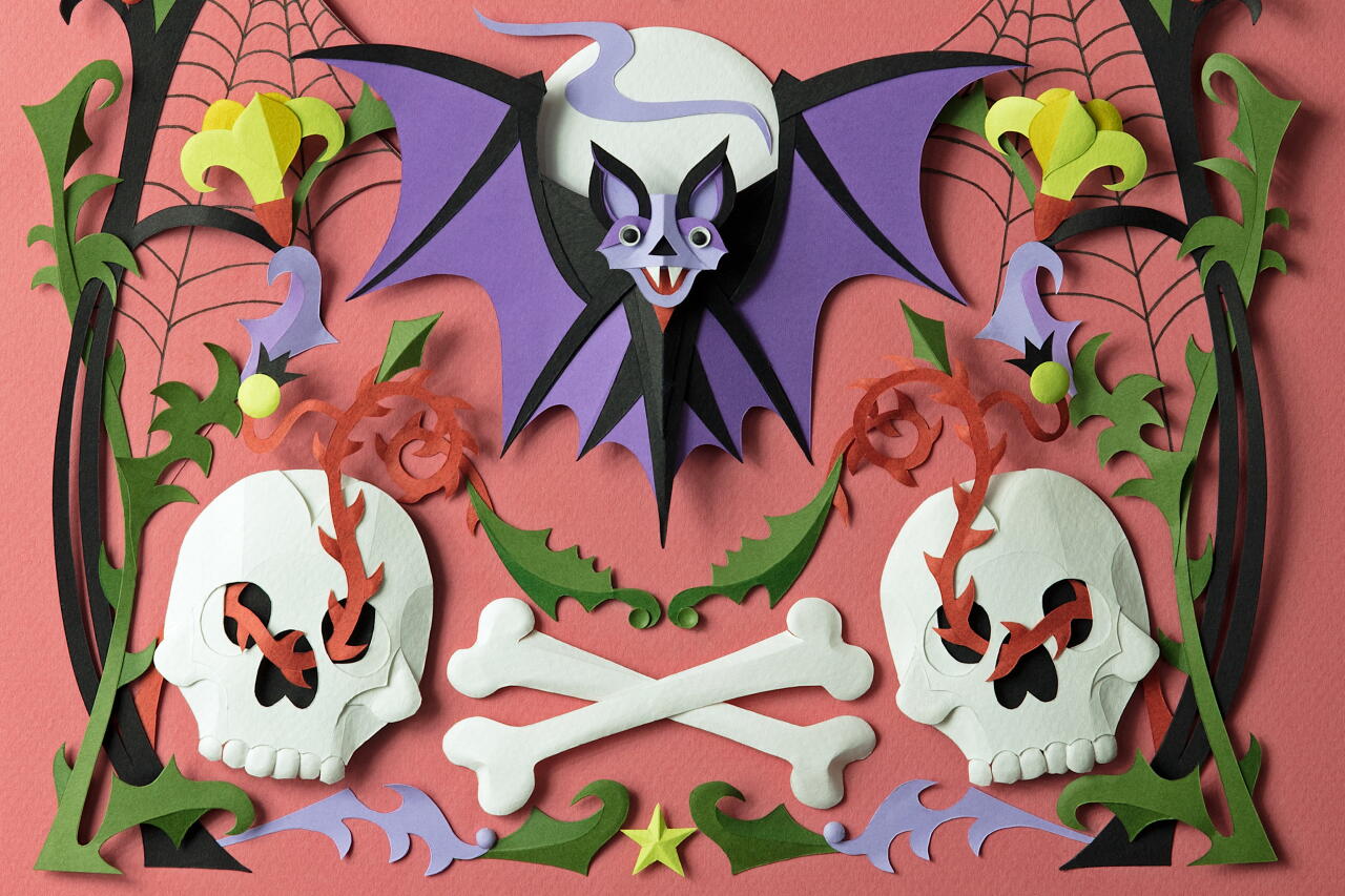Papercraft illustration of bat, skulls, bones and spiderwebs