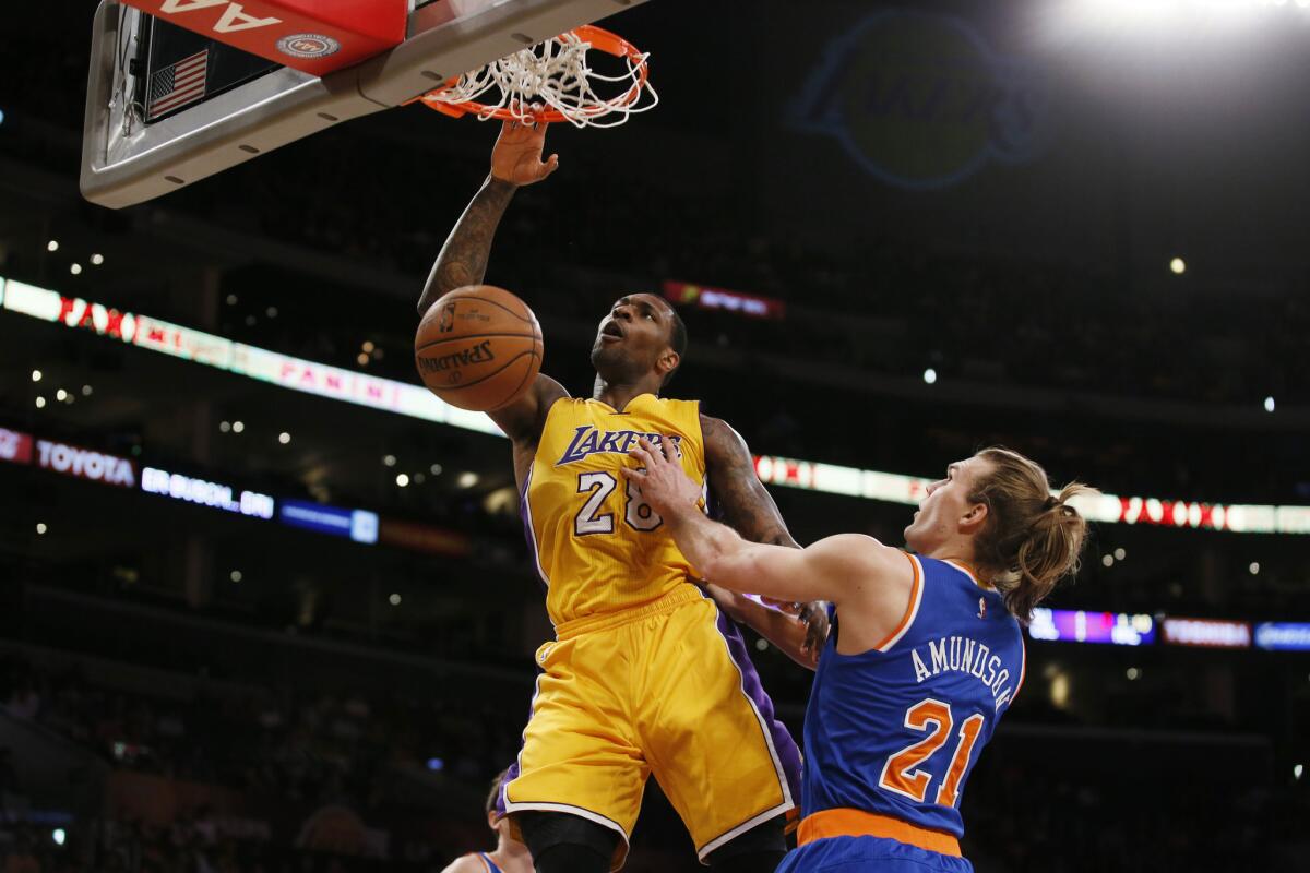 Lakers power forward Tarik Black dunks over Knicks forward Lou Amundson during a game earlier in the season.