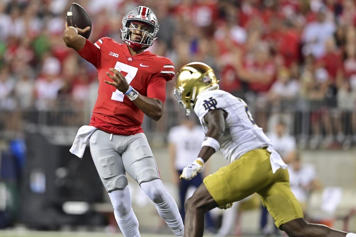 Ohio State quarterback C.J. Stroud throws while being pressured by Notre Dame safety DJ Brown during the second quarter of an NCAA college football game Saturday, Sept. 3, 2022, in Columbus, Ohio. (AP Photo/David Dermer)