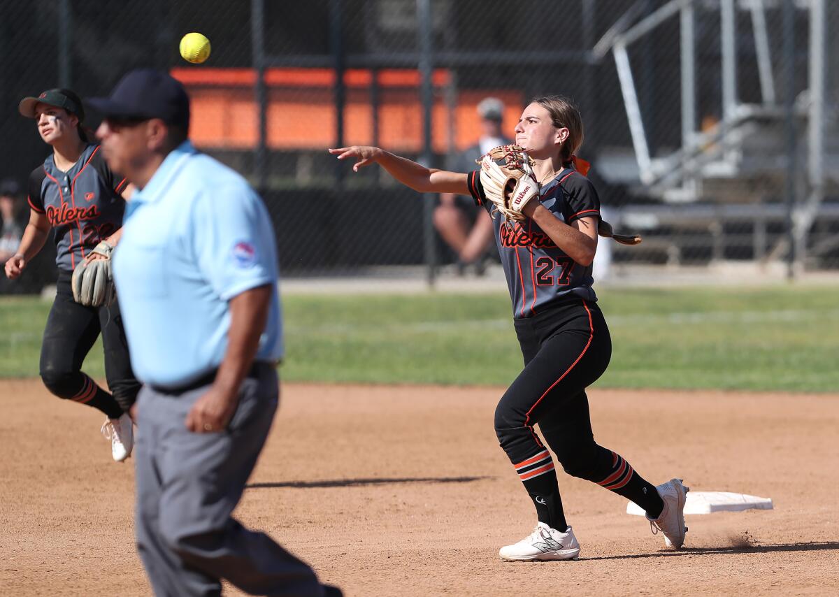 Macy Fuller (27) of Huntington Beach throws to first for an out against Murrieta Mesa on Thursday.