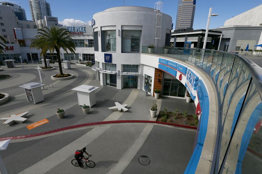 LONG BEACH, CALIF. -MAR. 25, 2020. The Pike in downtown Long Beach, a popular dining and entertainment area, is almost completely deserted because of the coronavirus lockdown. (Luis Sinco/Los Angeles Times)