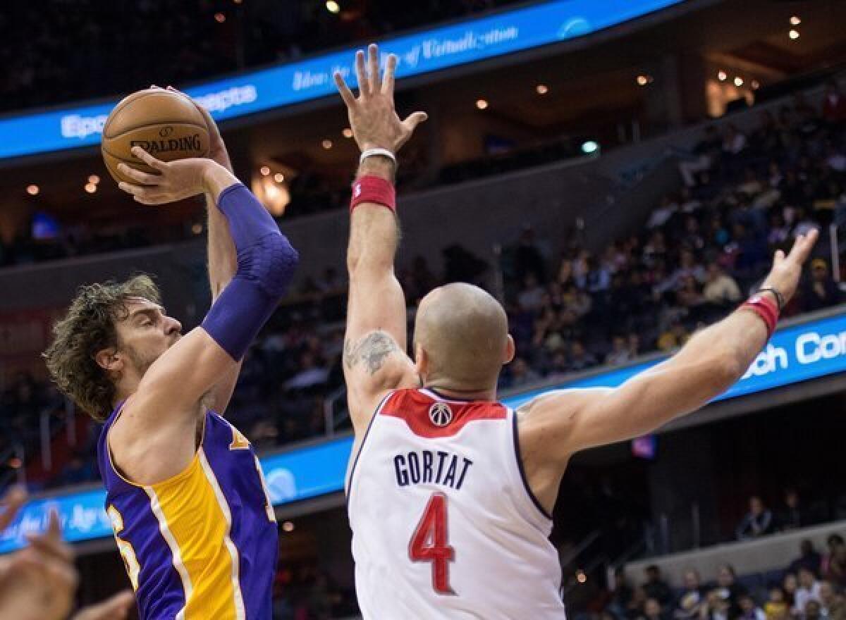 Paul Gasol shoots over Marcin Gortat during the Lakers' loss to the Washington Wizards, 116-111, on Tuesday at the Verizon Center in Washington, D.C.