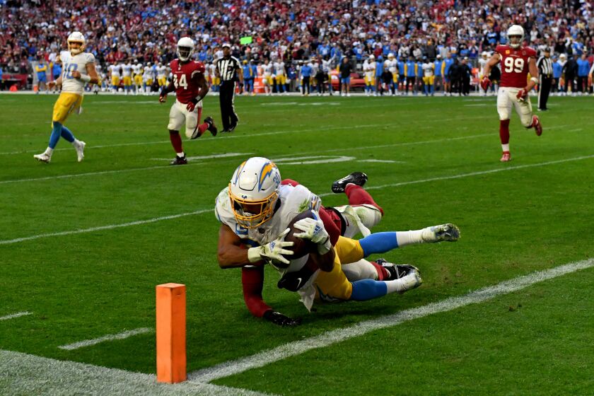 GLENDALE, ARIZONA - NOVEMBER 27: Austin Ekeler #30 of the Los Angeles Chargers scores on a rushing touchdown in the fourth quarter of a game against the Arizona Cardinals at State Farm Stadium on November 27, 2022 in Glendale, Arizona. (Photo by Norm Hall/Getty Images)