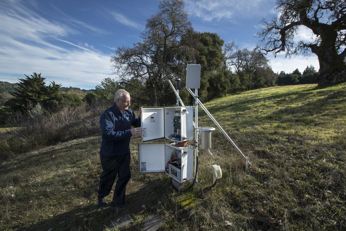Tom Bleier, recently retired chief technology officer for QuakeFinder, with a magnetometer and ion system used to measure magnetic field changes and air ion detection underground that helps in forecasting earthquakes.