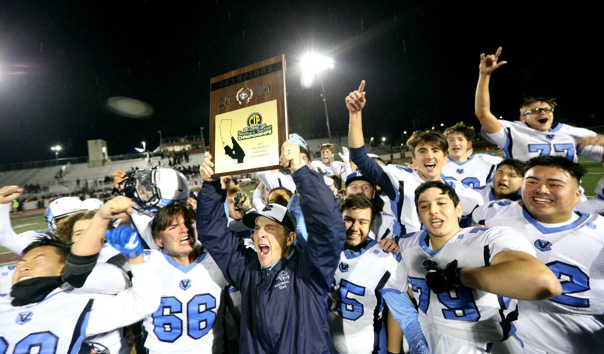Crescenta Valley High first-year football coach Hudson Gossard and the team celebrate their CIF Southern Section Division X championship win Friday against host Simi Valley.