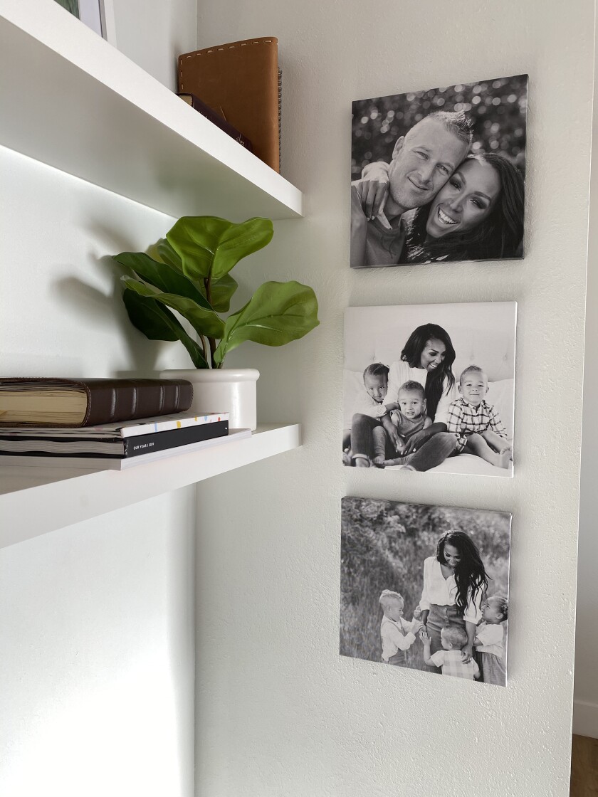 Canvas tiles printed with a customer's photos hang on a wall. 
