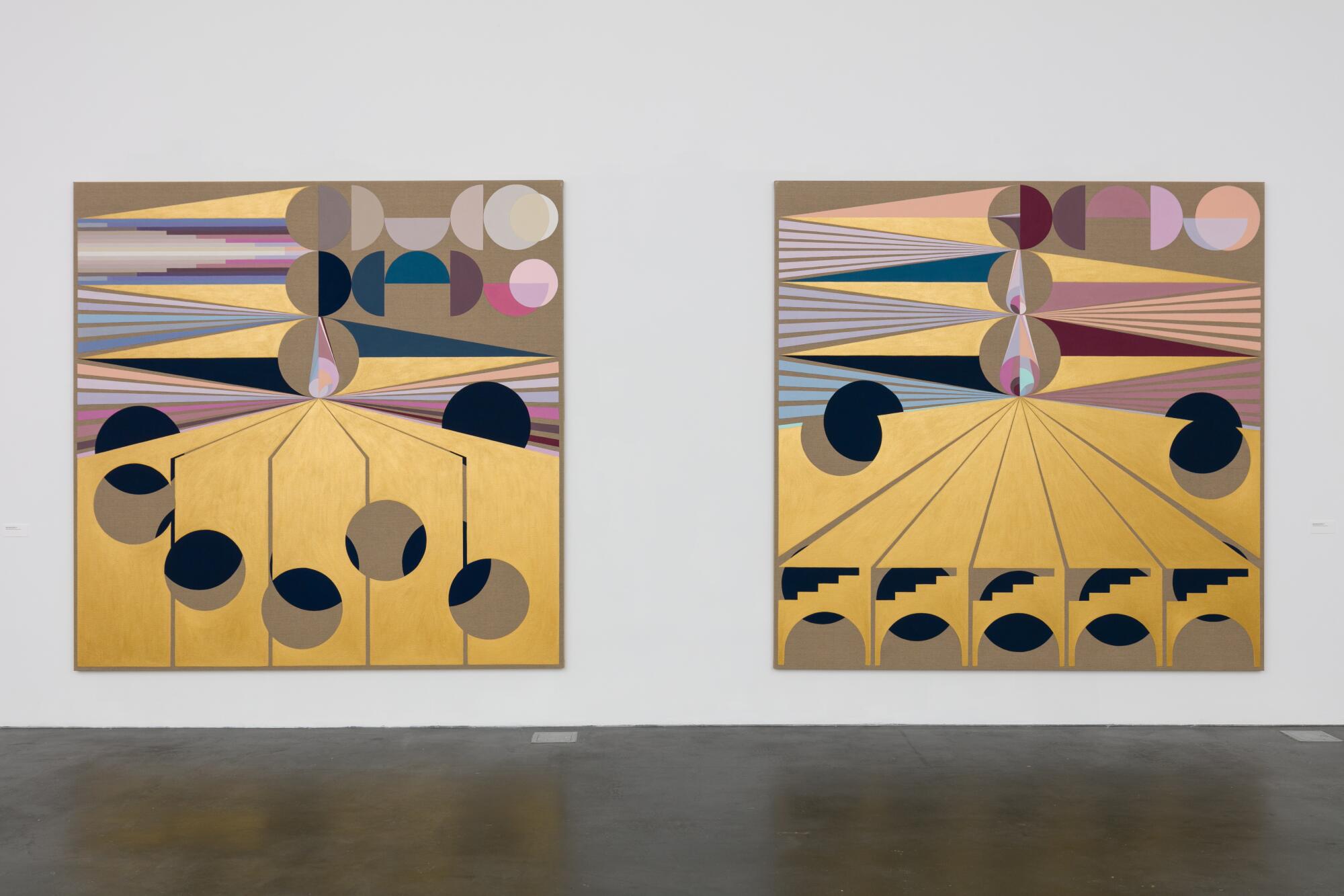 A pair of paintings bear geometric motifs — including elements painting in shimmering gold — hang on a gallery wall