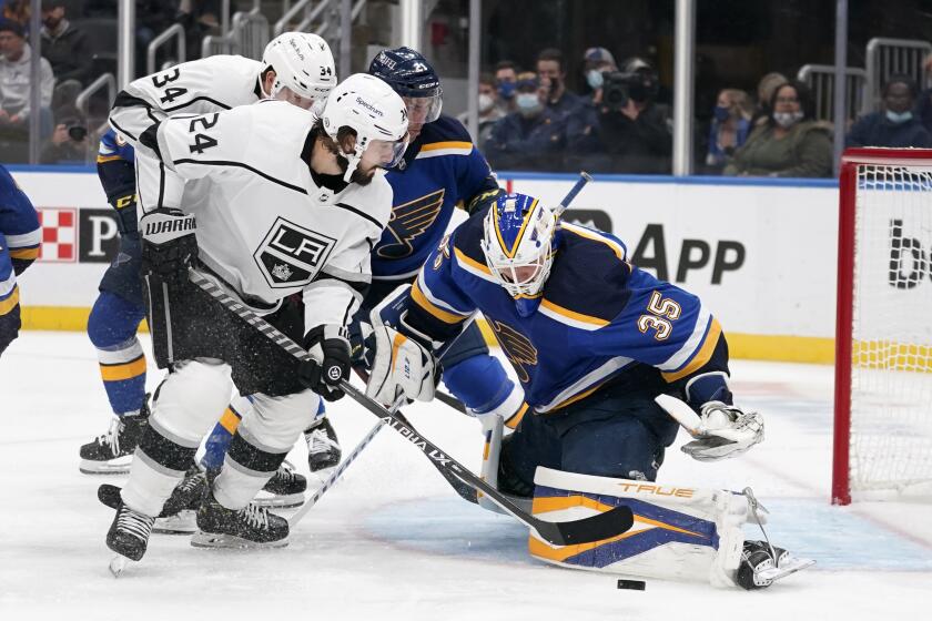 Los Angeles Kings' Phillip Danault (24) is unable to score past St. Louis Blues goaltender Ville Husso (35) during the third period of an NHL hockey game Monday, Oct. 25, 2021, in St. Louis. (AP Photo/Jeff Roberson)