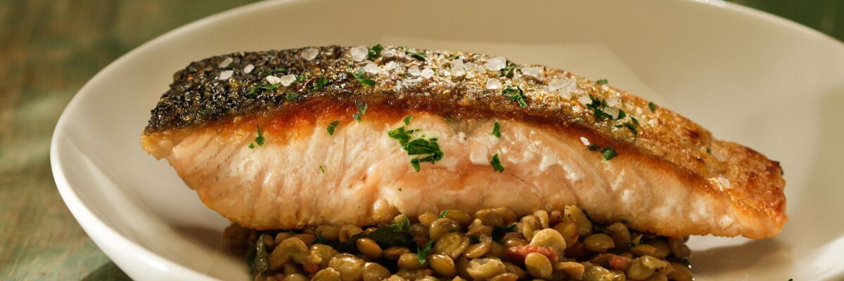 Recipe: Crisp-skinned salmon with lentils, bacon and dandelion greens