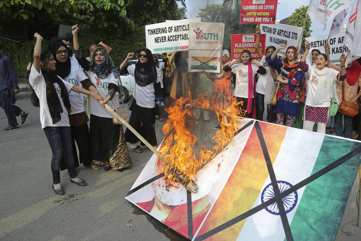 Pakistani students in Lahore burn a poster of Indian Premier Narendra Modi