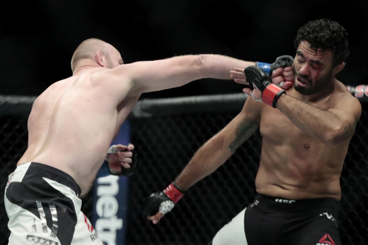Tim Boetsch, left, connects with a punch against Rafael Natal during a middleweight bout at UFC 205.