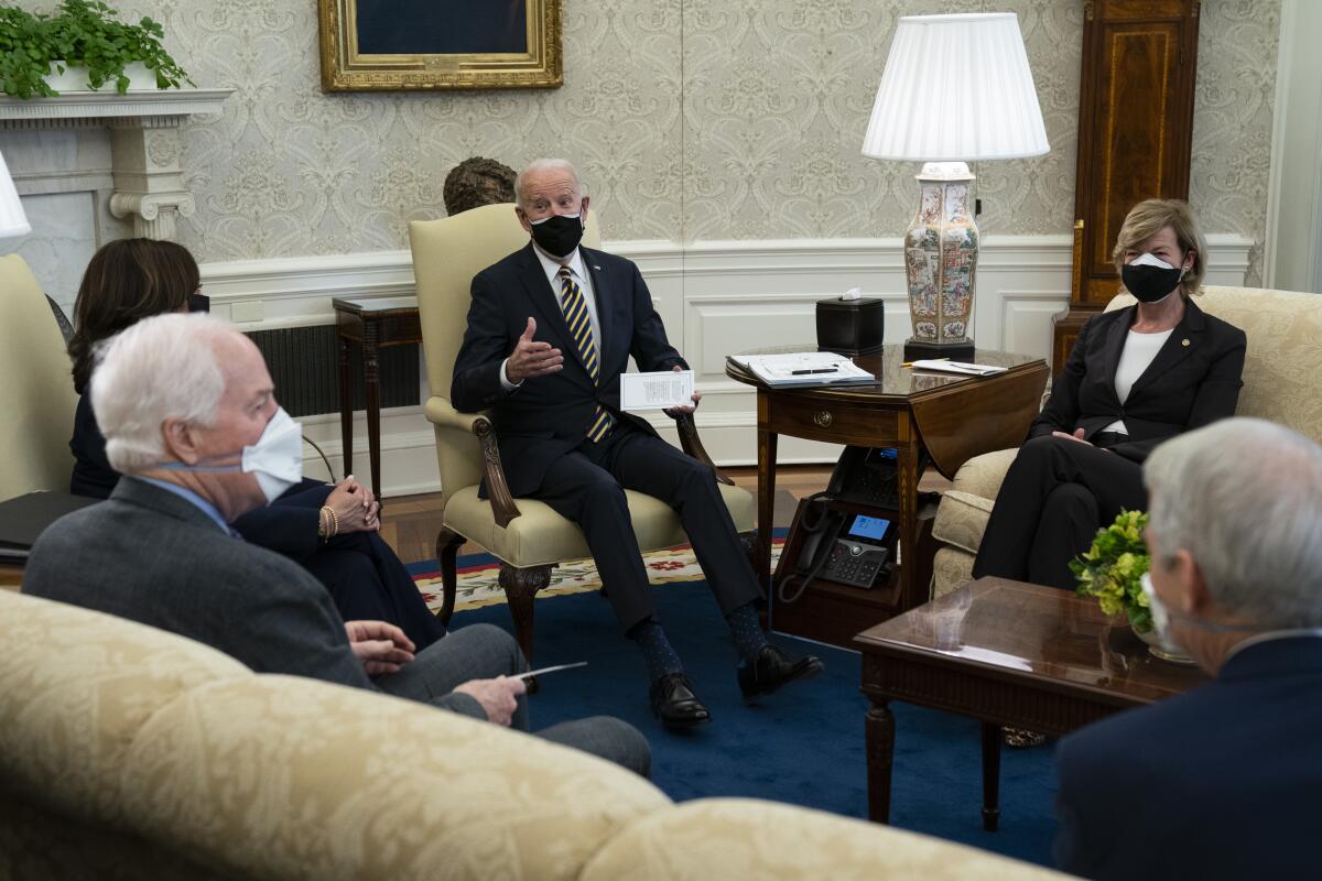 President Biden speaks with lawmakers in the Oval Office.