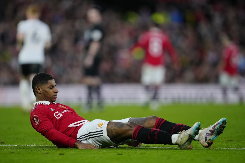Manchester United's Marcus Rashford is on the ground during the English FA Cup quarterfinal soccer match between Manchester United and Fulham at the Old Trafford stadium in Manchester, England, Sunday, March 19, 2023. (AP Photo/Jon Super)