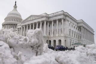 The U.S Capitol is photographed past piles of snow on Thursday, Jan. 18, 2024, in Washington. (AP Photo/Mariam Zuhaib)