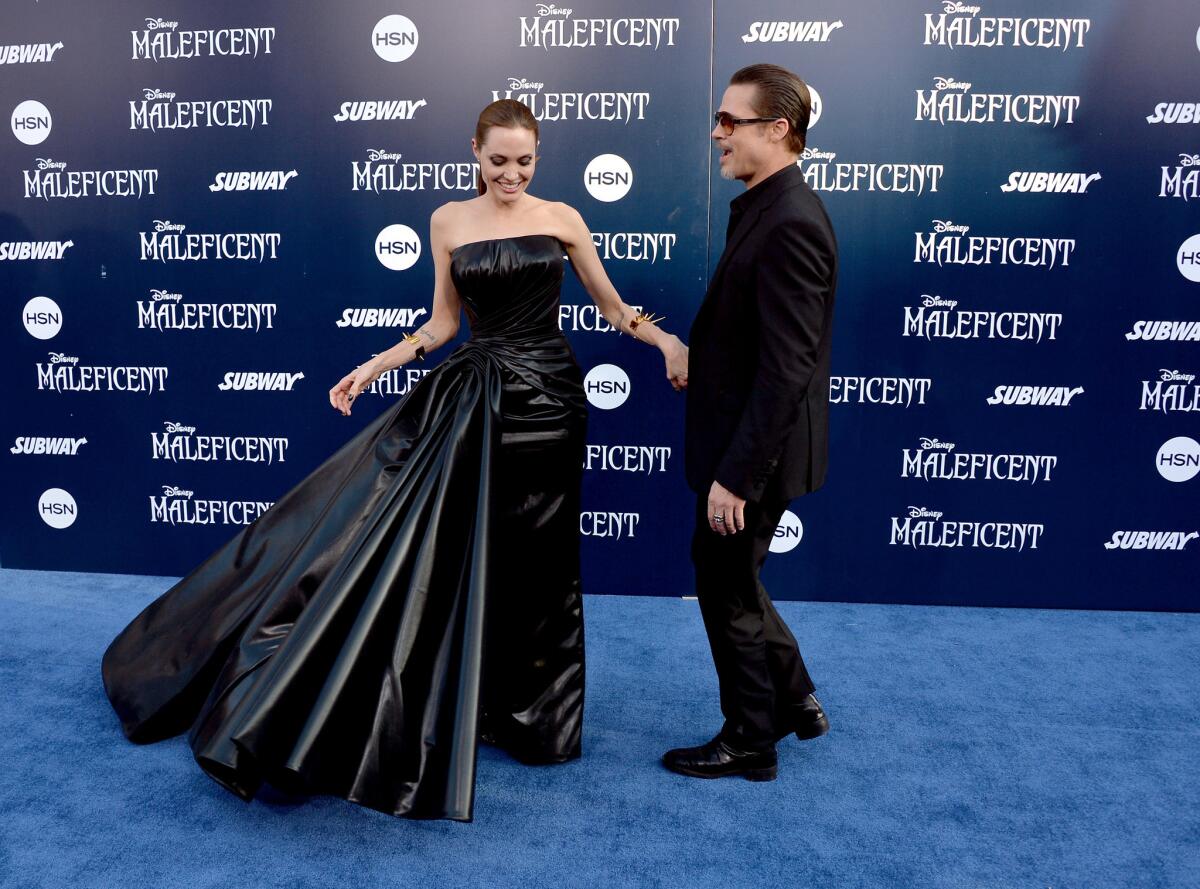 Angelina Jolie and Brad Pitt enjoy a light moment at the world premiere of Disney's "Maleficent" at the El Capitan Theatre.