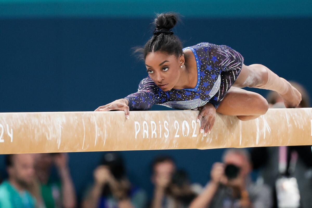 Simone Biles performs on the balance beam during the women's all-around individual finals 