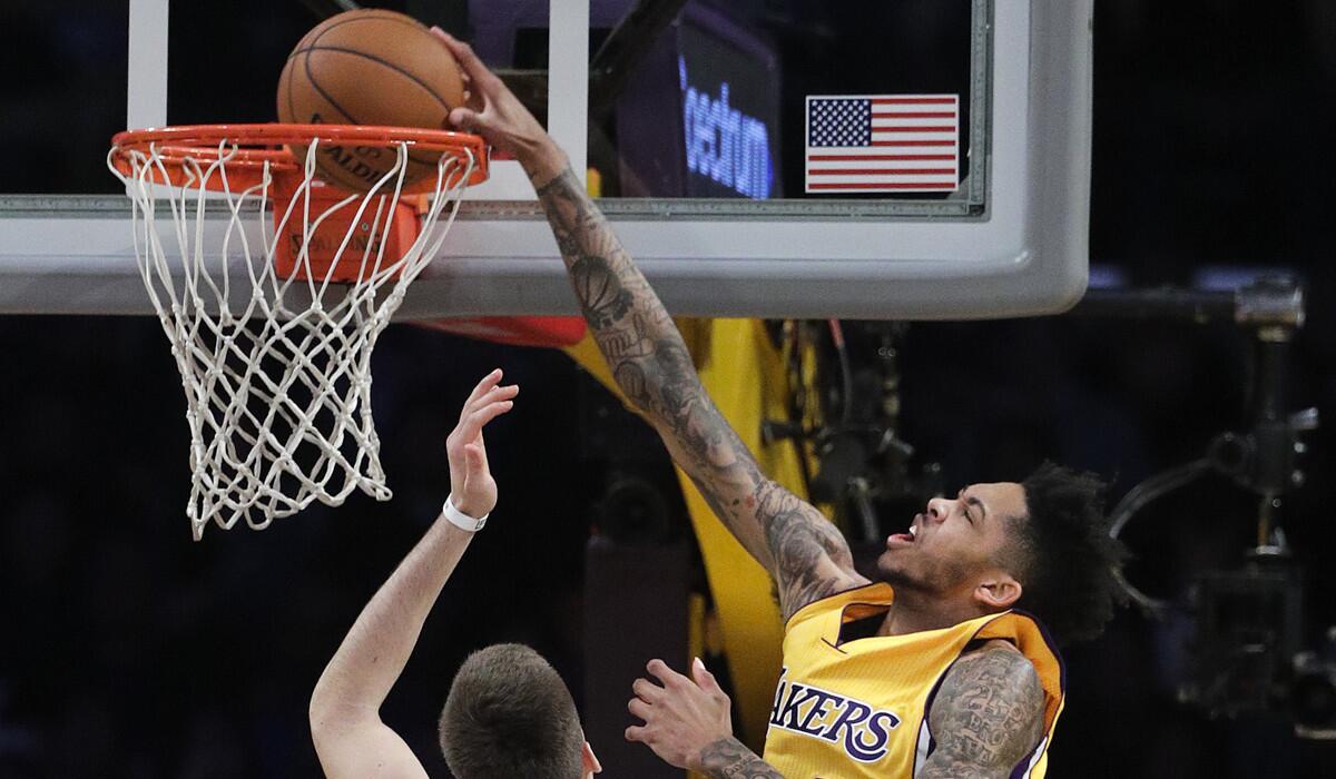 Lakers' Brandon Ingram dunks over the Denver Nuggets during the first half Tuesday.