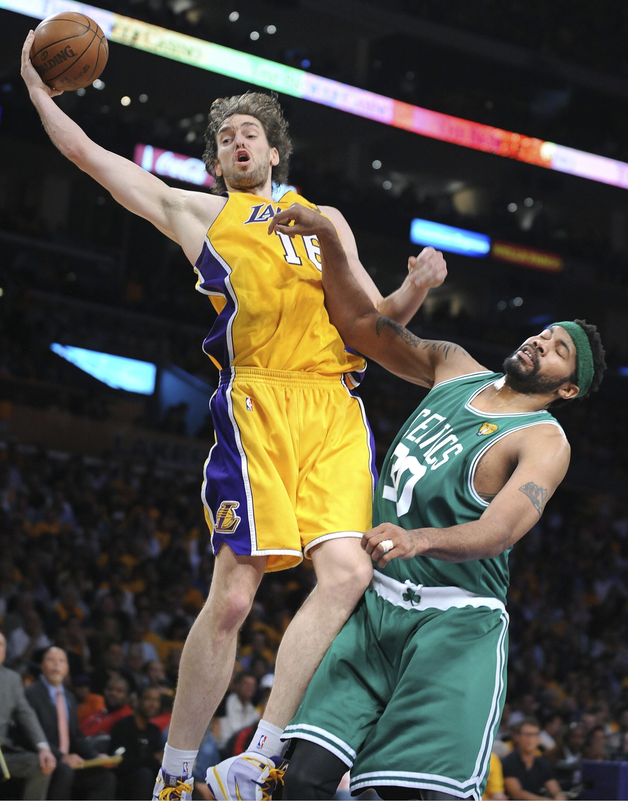 Lakers forward Pau Gasol hauls in a pass above Celtics forward Rasheed Wallace during Game 1 of the 2010 NBA Finals.