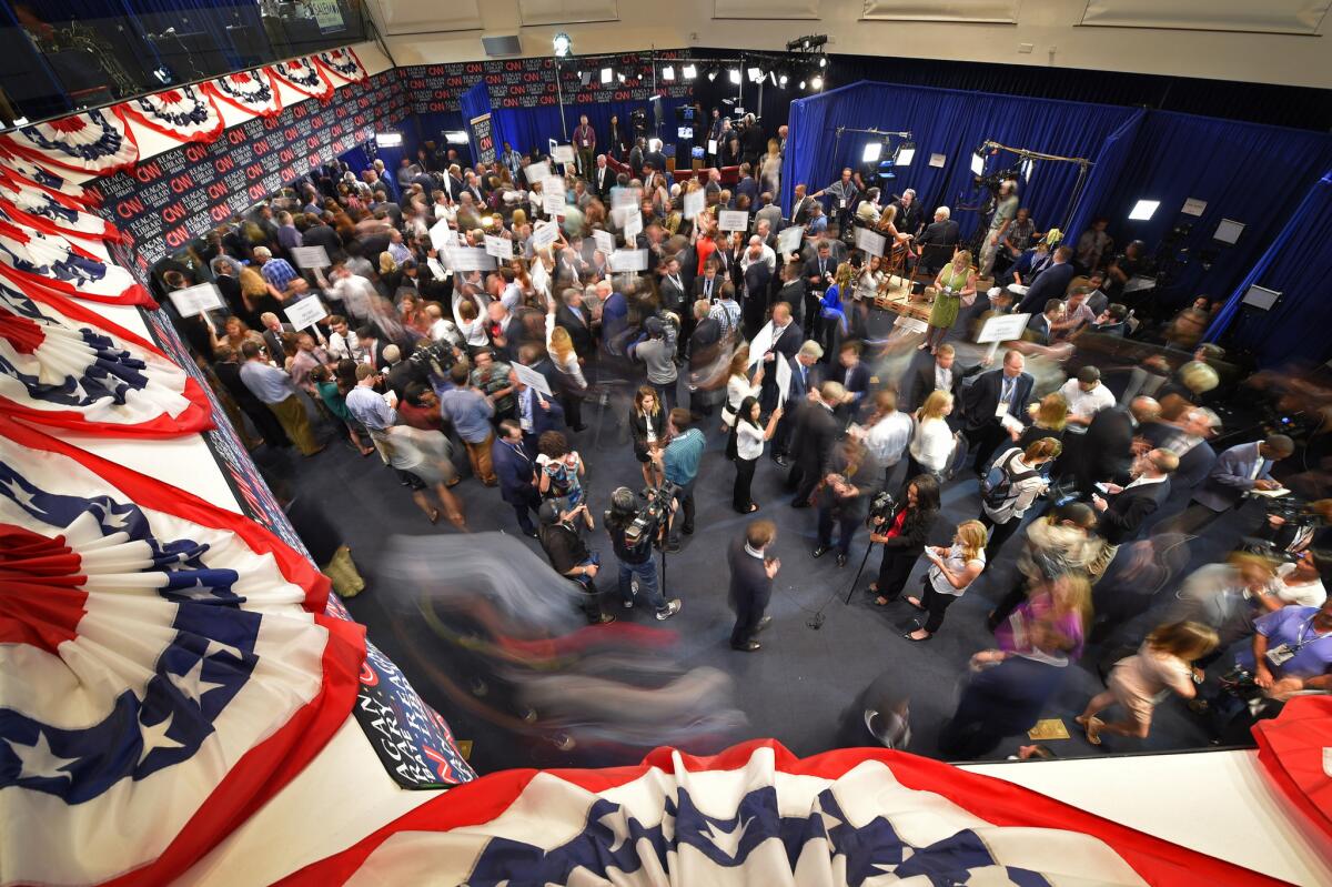 Journalists, candidates and their representatives crowd the spin room following the CNN Republican presidential debate at the Ronald Reagan Presidential Library and Museum in Simi Valley.