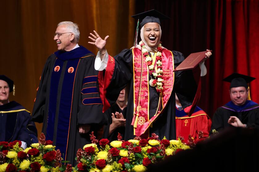 LOS ANGELES-CA-MAY 10, 2024: USC valedictorian Asna Tabassum receives her diploma on stage beside Dean of the USC Viterbi School of Engineering Yannis C. Yortsos at the Galen Center in Los Angeles on May 10, 2024. (Christina House / Los Angeles Times)