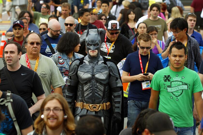 Jordan Krueger of San Antonio, dressed as Batman, heads to preview night at Comic-Con on Wednesday, July 11, 2012.